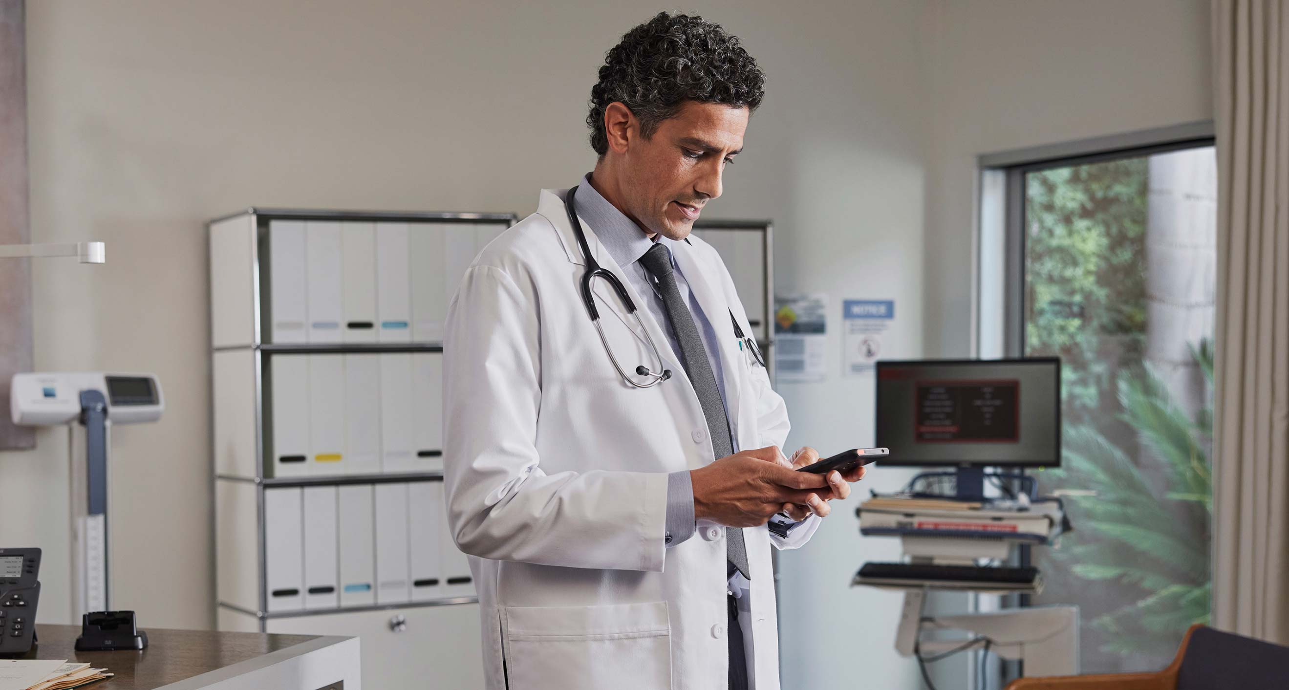 A doctor uses Webex to manage patient care