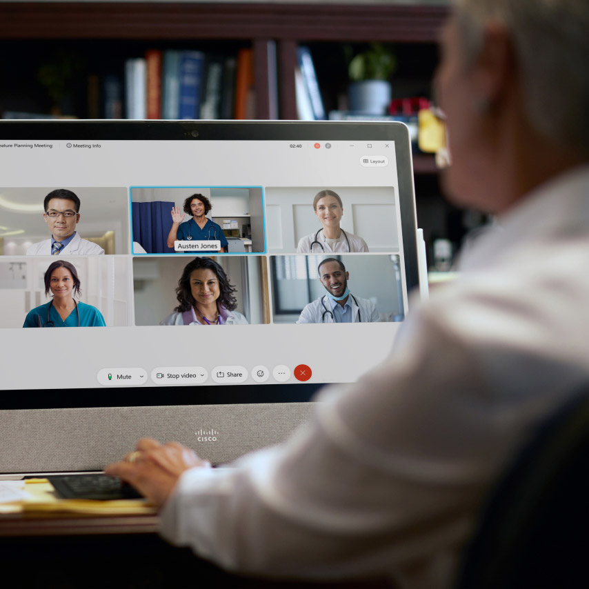 A doctor connects with other health care professionals using Webex