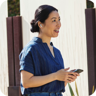 A person uses Webex Assistant on-the-go while taking a video meeting from her mobile phone.