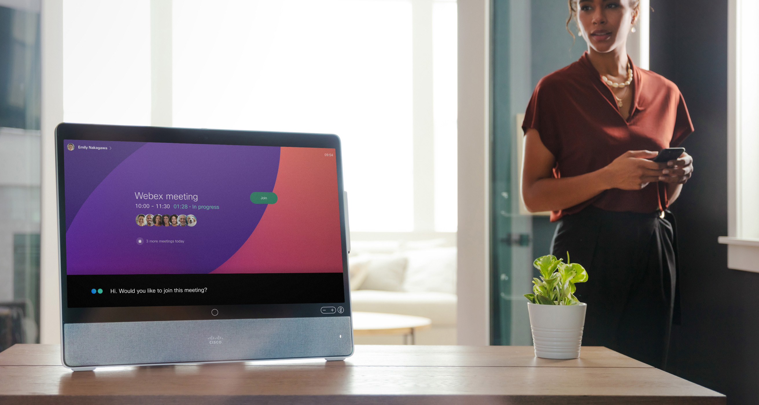 Webex Assistant asks a businessperson if they'd like to join their next meeting, speaking from the Webex Desk Pro in their office.