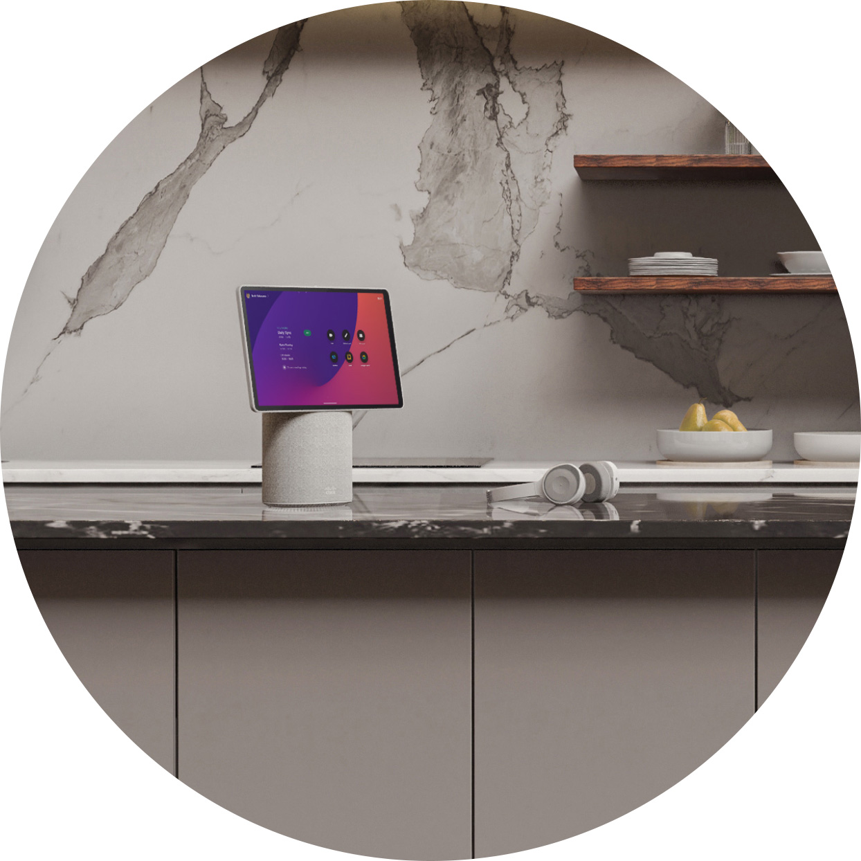A Webex Desk Mini and a headset rest on the counter of a modern kitchen, replete with faux marble surfaces and minimalist cabinetry.